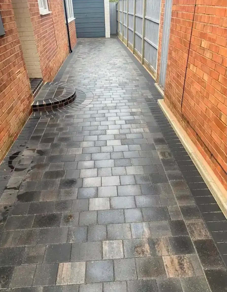 Grey block paving with a step