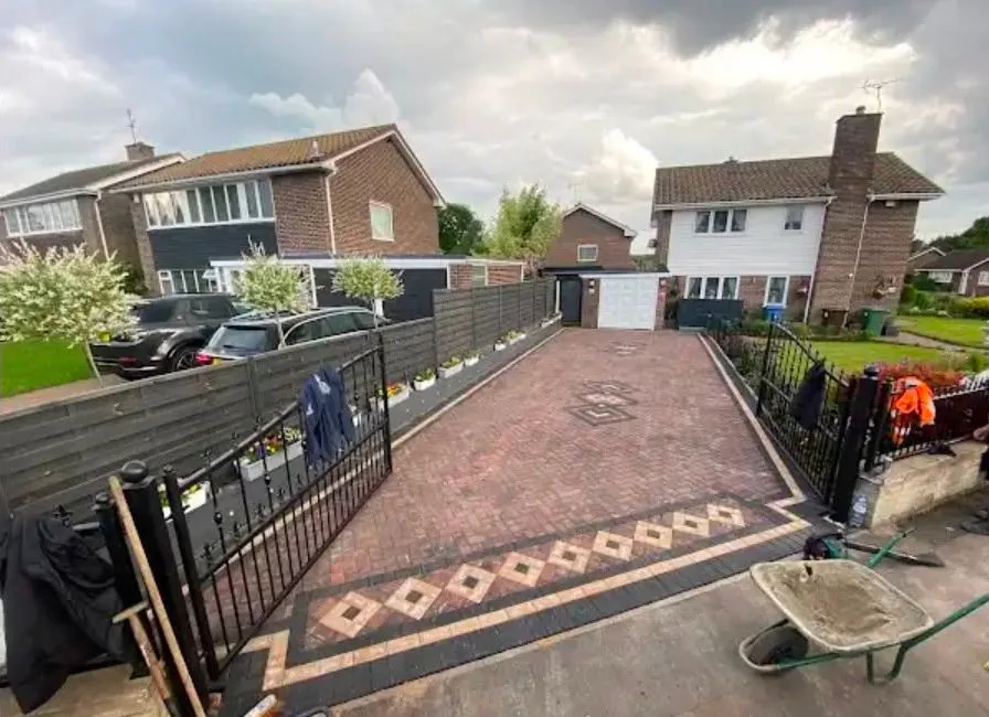 Block paved driveway with iron gates