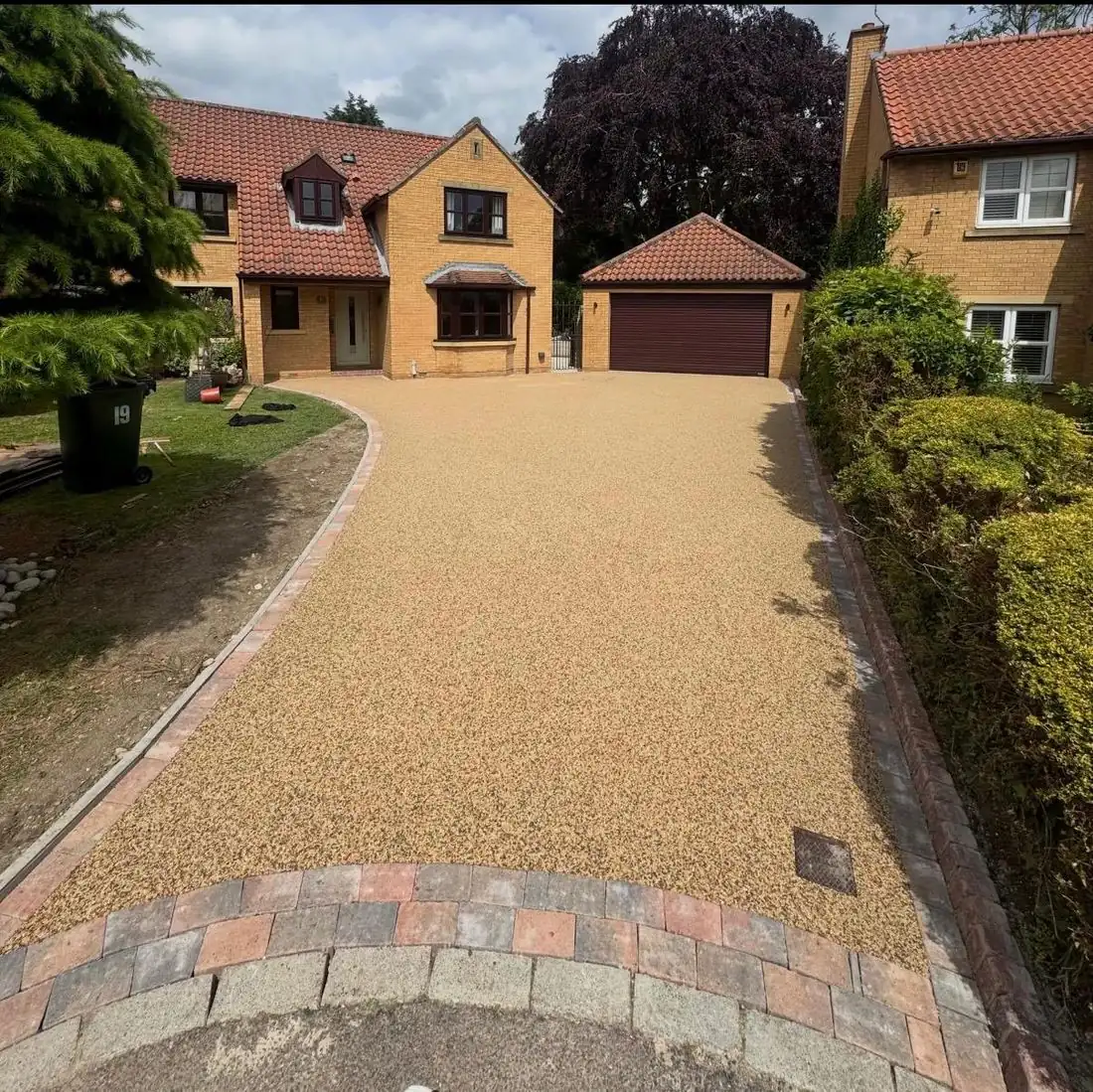 Gold resin bound driveway with a block border