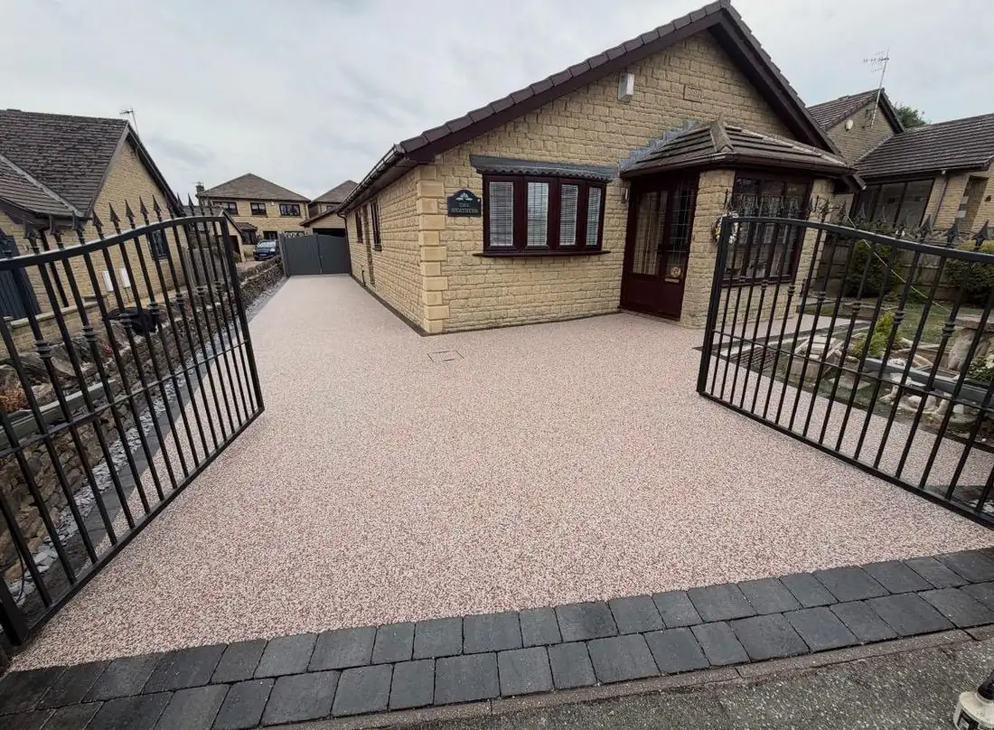 Red resin bound driveway with iron gates