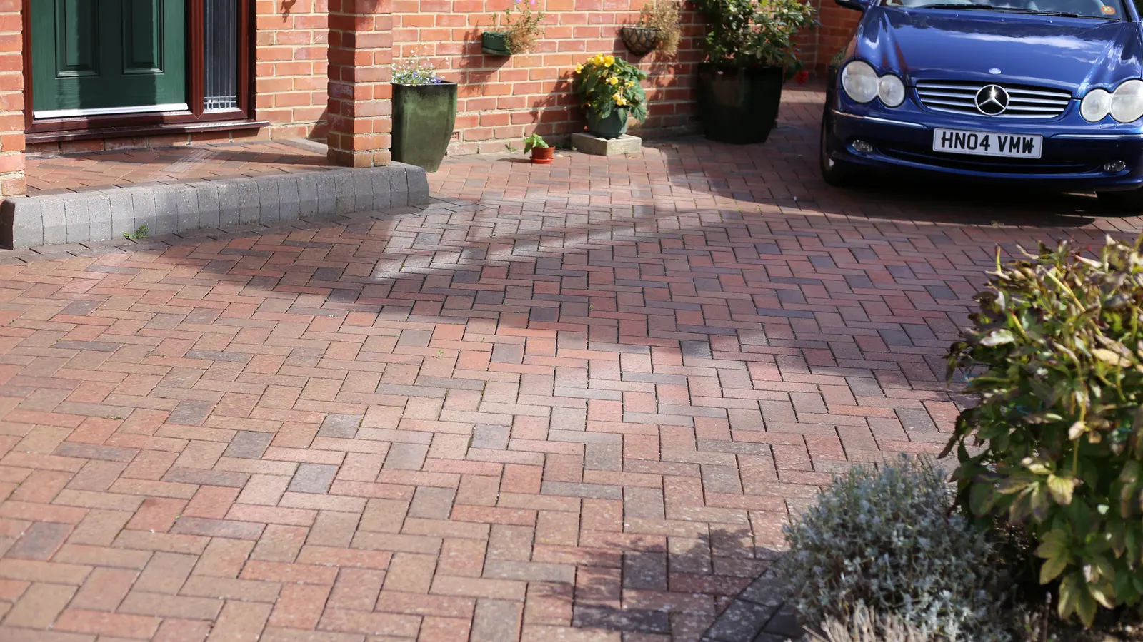 A block paved and gravel driveway at a house